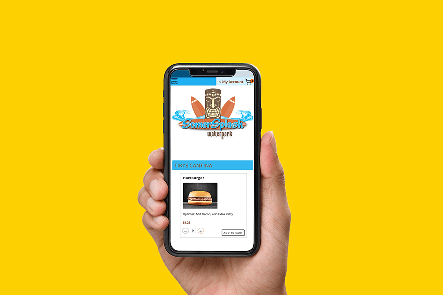 A hand using their phone to order a cheeseburger
